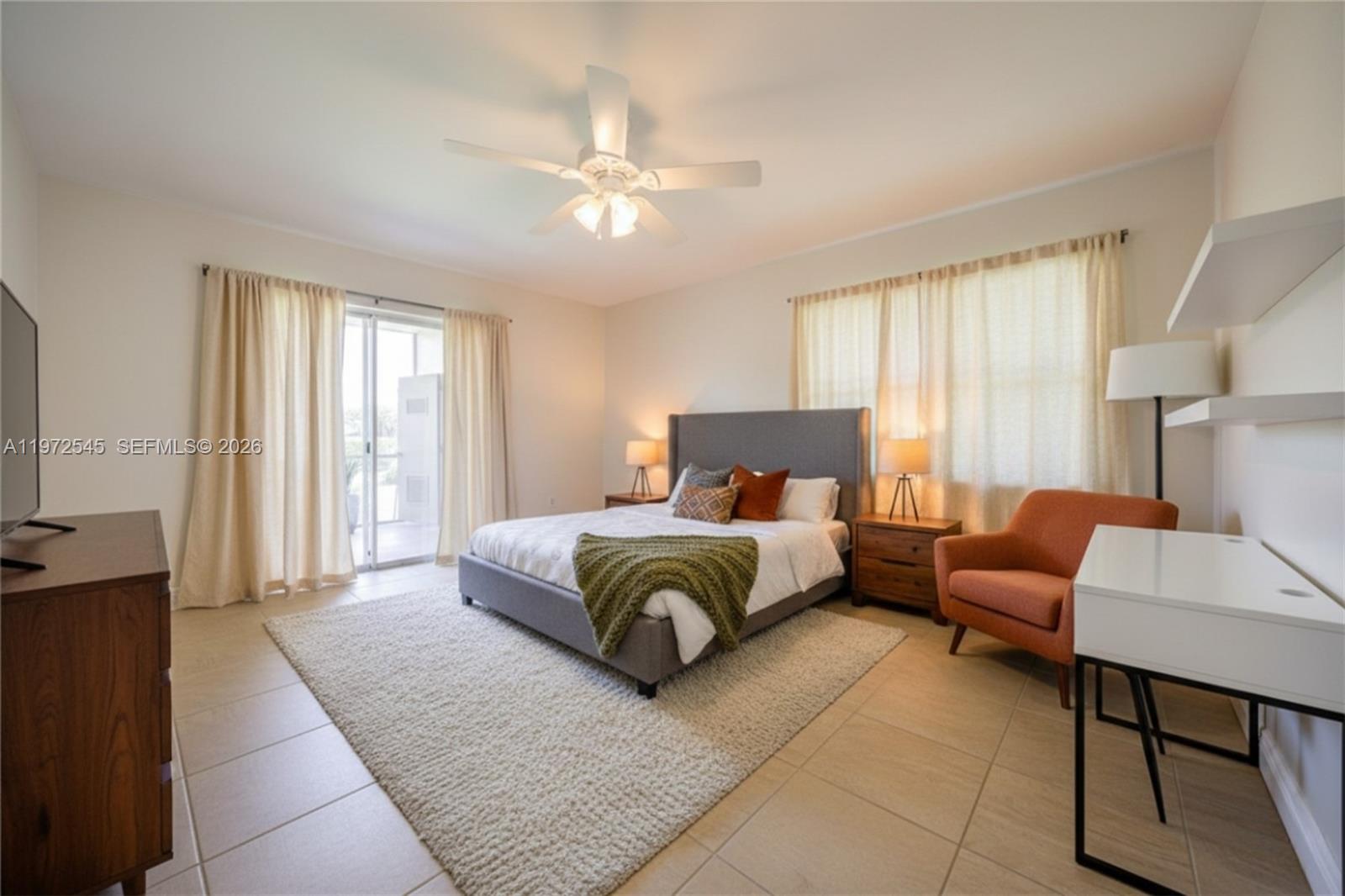15285 Southwest 107th Lane, Unit 201 Miami, FL 33196 - Photo 9 of 28 a spacious bedroom with a bed and a couch
