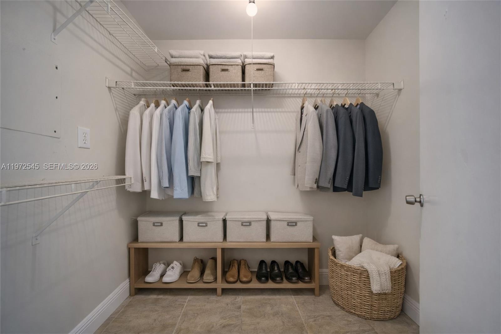 15285 Southwest 107th Lane, Unit 201 Miami, FL 33196 - Photo 10 of 28 a view of walk in closet with clothes and shoes