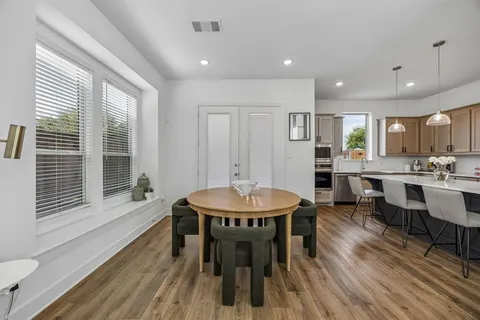a view of a a dining room with furniture window and wooden floor