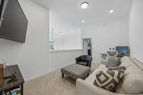 a bedroom with furniture and a flat screen tv
