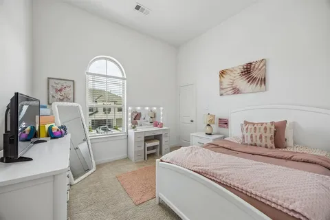 a bedroom with a bed and a desk