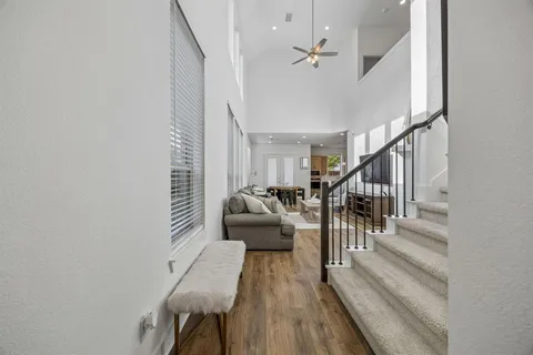 a view of entryway and hall with wooden floor