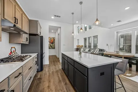 a kitchen with stainless steel appliances granite countertop a sink stove and refrigerator