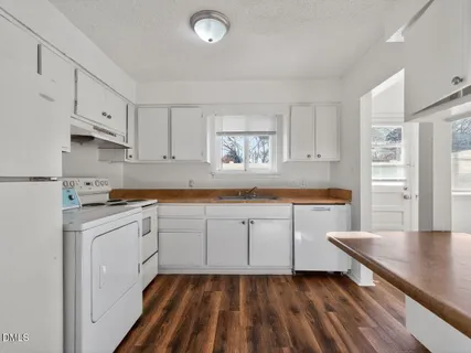 a kitchen with cabinets oven and a dishwasher