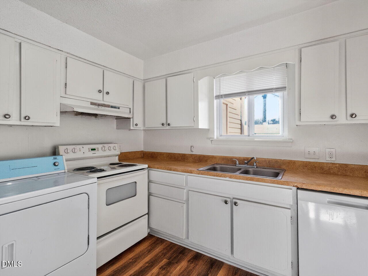 2304 Champion Court, Unit 2304 Raleigh, NC 27606 - Photo 22 of 35 a kitchen with white cabinets and white appliances