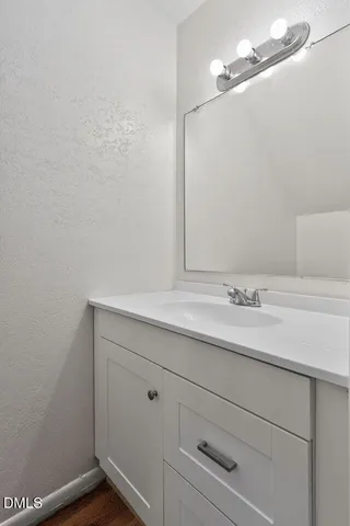 a bathroom with a sink and vanity