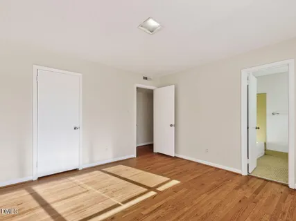 a view of an empty room and wooden floor
