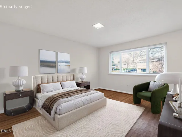 a bedroom with a bed wooden floor and lamp