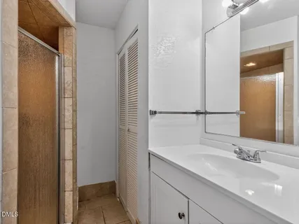 a bathroom with a double vanity sink and a mirror