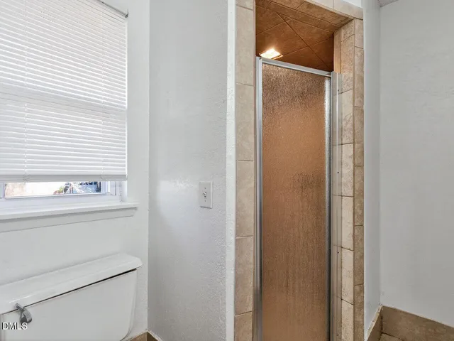 a bathroom with a shower and a sink