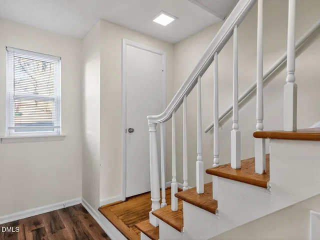 a view of entryway with wooden floor and stairs