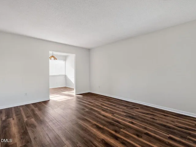 a view of an empty room and wooden floor