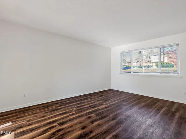 a view of wooden floor and windows in a room