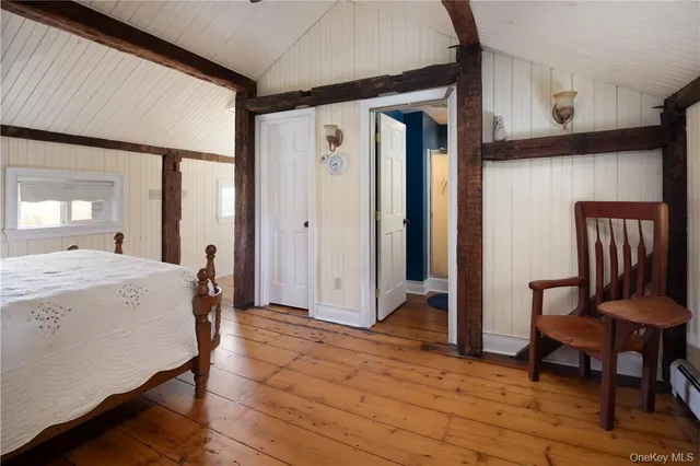 a spacious bedroom with a bed a table and chair