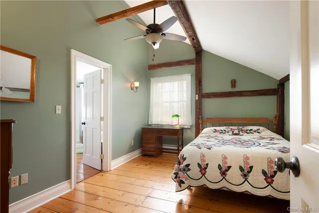 a bedroom with a bed and a mirror