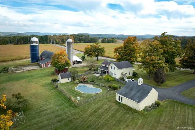 a view of a house with a yard and lake view