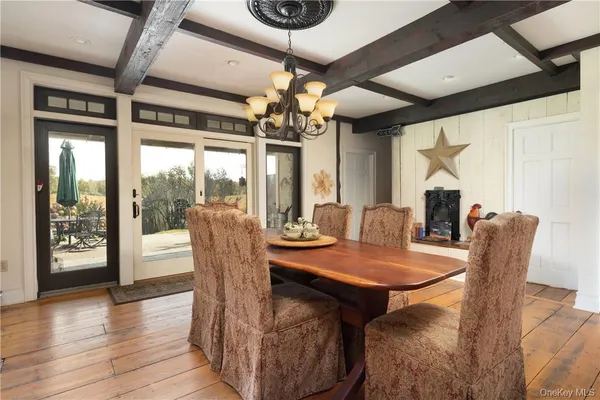 a dining room with furniture wooden floor a chandelier