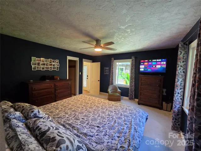 a bedroom with a bed and a television in it