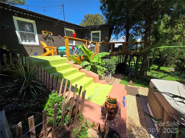a yard with lots of green space and trees all around