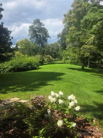 a view of a garden with a building in the background