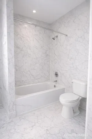 a bathroom with a toilet and a bathtub