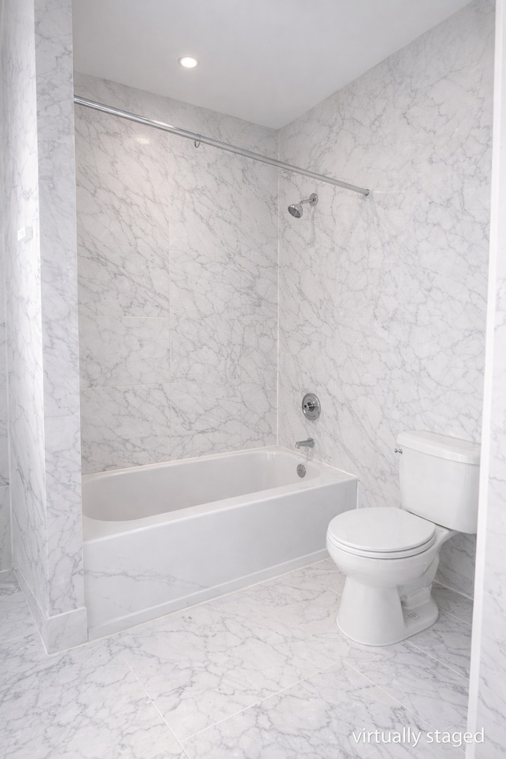 539 West 119th Street Chicago, IL 60628 - Photo 8 of 19 a bathroom with a toilet and a bathtub