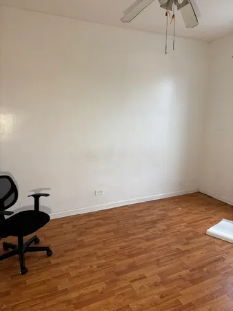 a view of an empty room and wooden floor