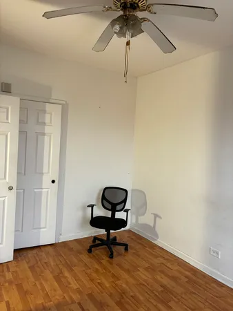 a view of a workspace with wooden floor