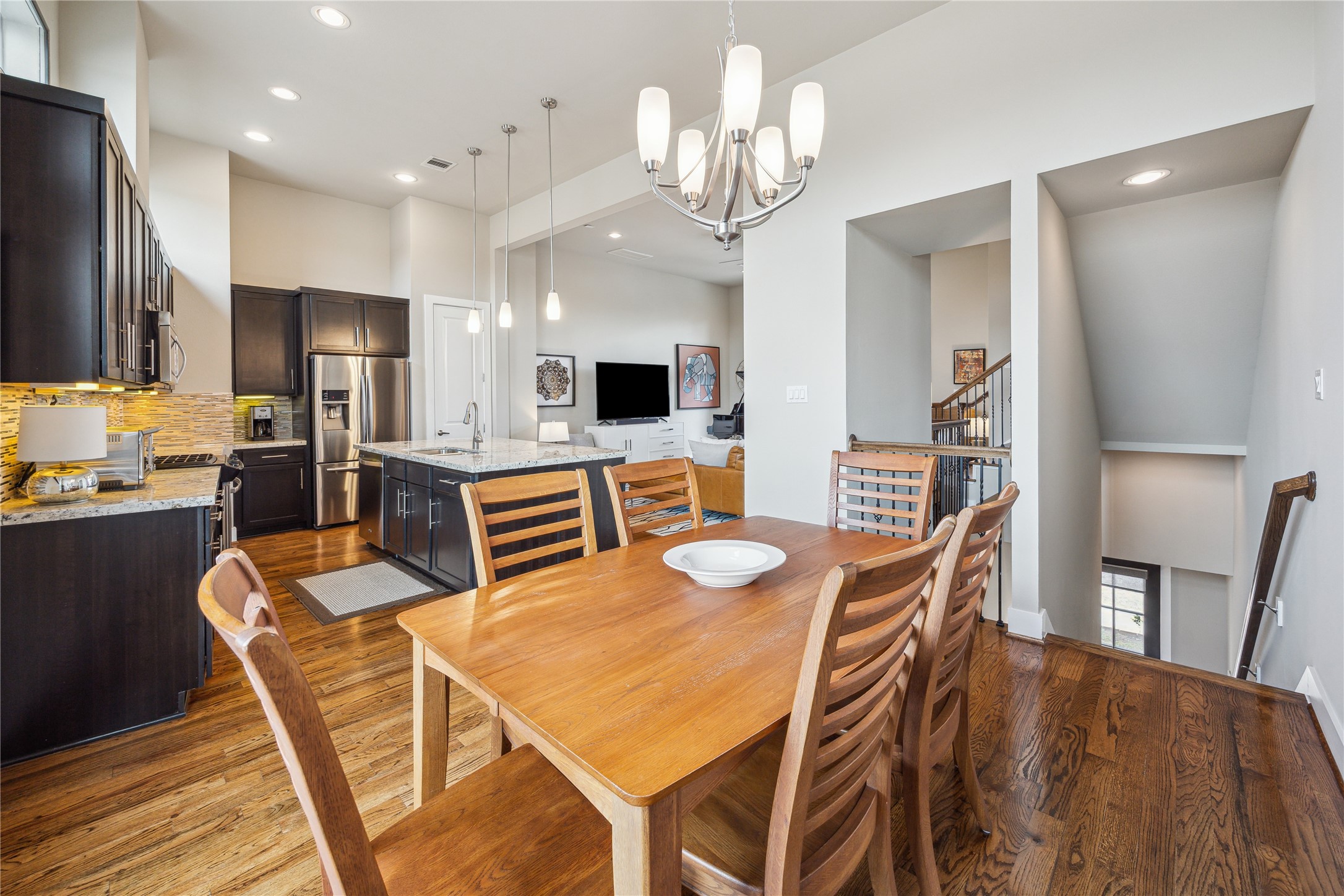4102 Marina Street Houston, TX 77007 - Photo 6 of 23 a kitchen with stainless steel appliances kitchen island granite countertop a dining table chairs and refrigerator