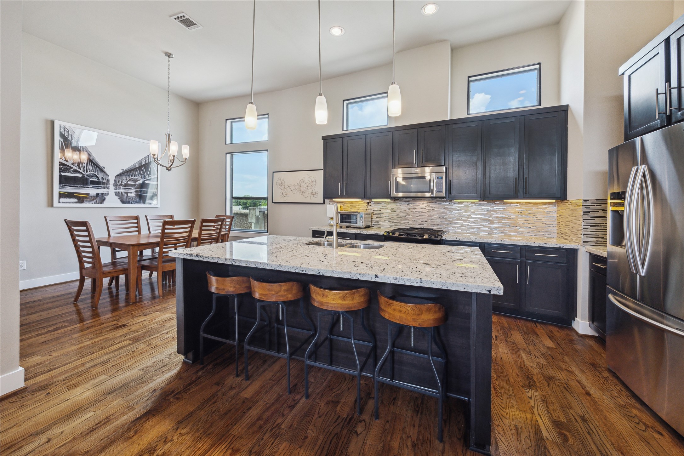 4102 Marina Street Houston, TX 77007 - Photo 10 of 23 a kitchen with stainless steel appliances granite countertop a table chairs sink refrigerator and cabinets