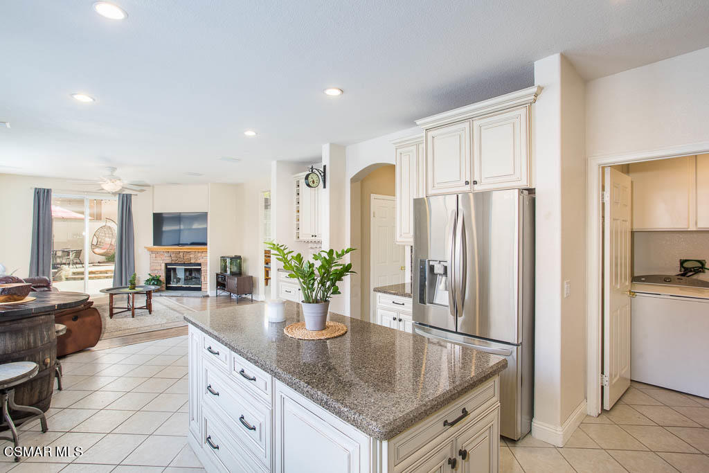 1902 Winterdew Avenue Simi Valley, CA 93065 - Photo 11 of 29 a kitchen with stainless steel appliances granite countertop a refrigerator a sink dishwasher and white cabinets with wooden floor