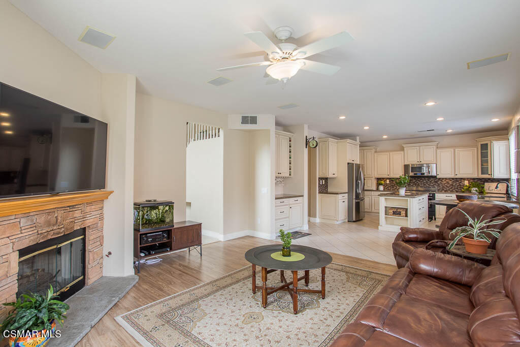 1902 Winterdew Avenue Simi Valley, CA 93065 - Photo 13 of 29 a living room with furniture kitchen view and a fireplace