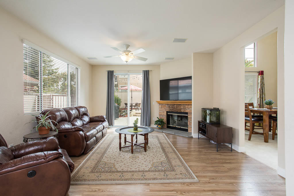 1902 Winterdew Avenue Simi Valley, CA 93065 - Photo 14 of 29 a living room with furniture a fireplace a flat screen tv and large windows