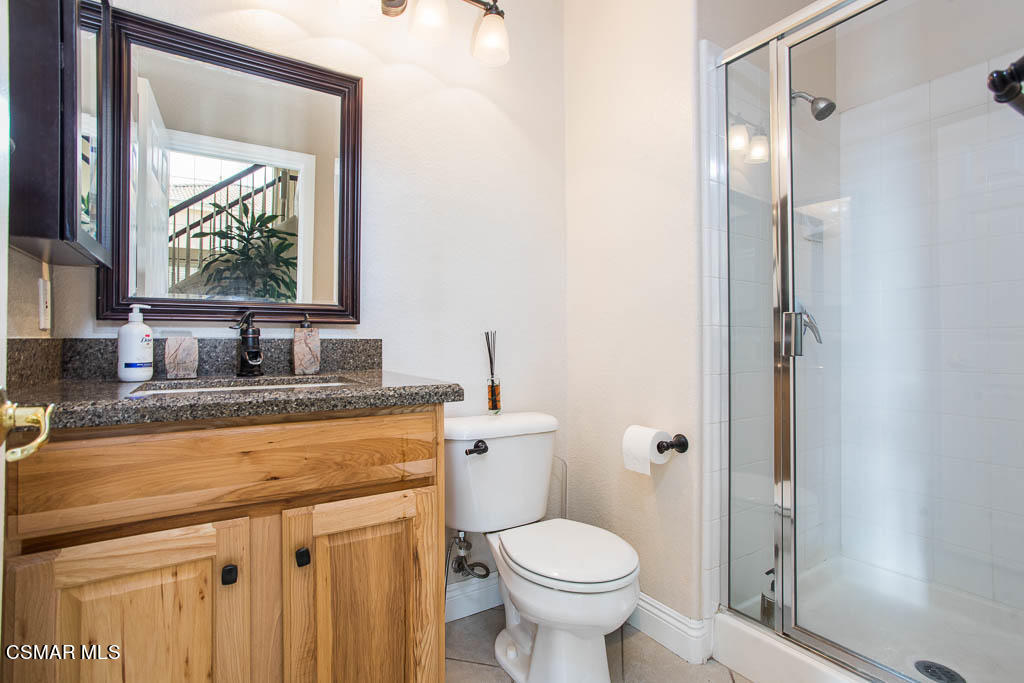 1902 Winterdew Avenue Simi Valley, CA 93065 - Photo 16 of 29 a bathroom with a granite countertop sink toilet and mirror