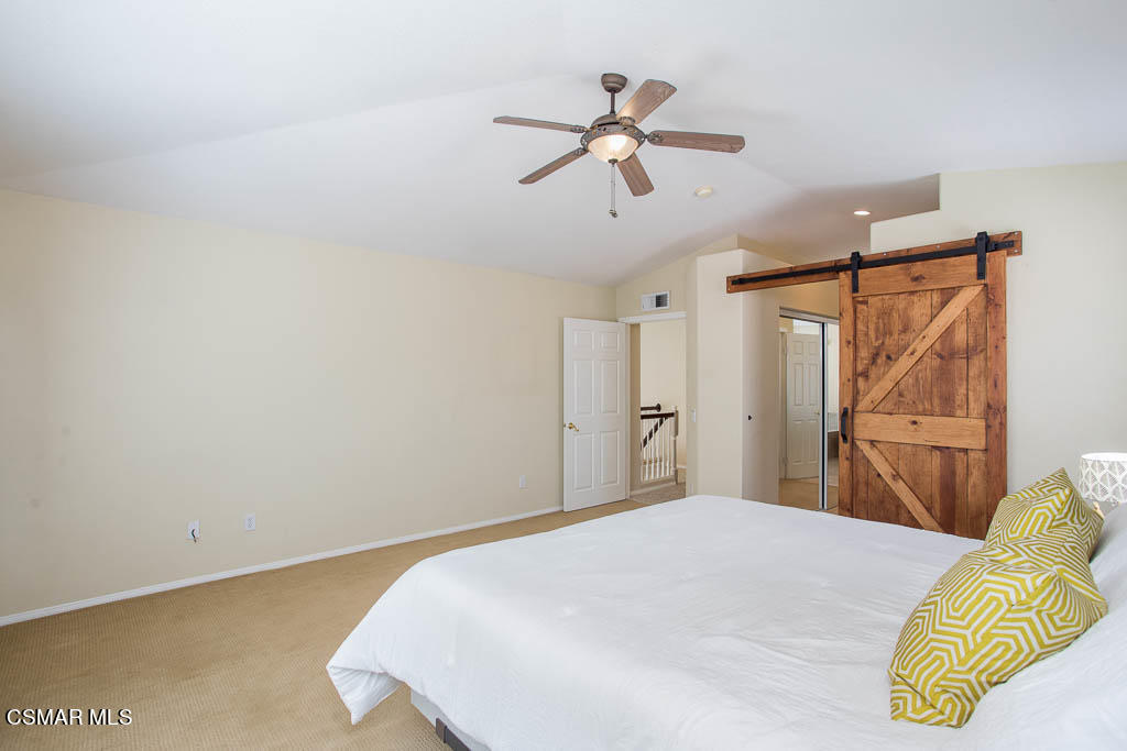 1902 Winterdew Avenue Simi Valley, CA 93065 - Photo 18 of 29 a bedroom with a bed and a chandelier