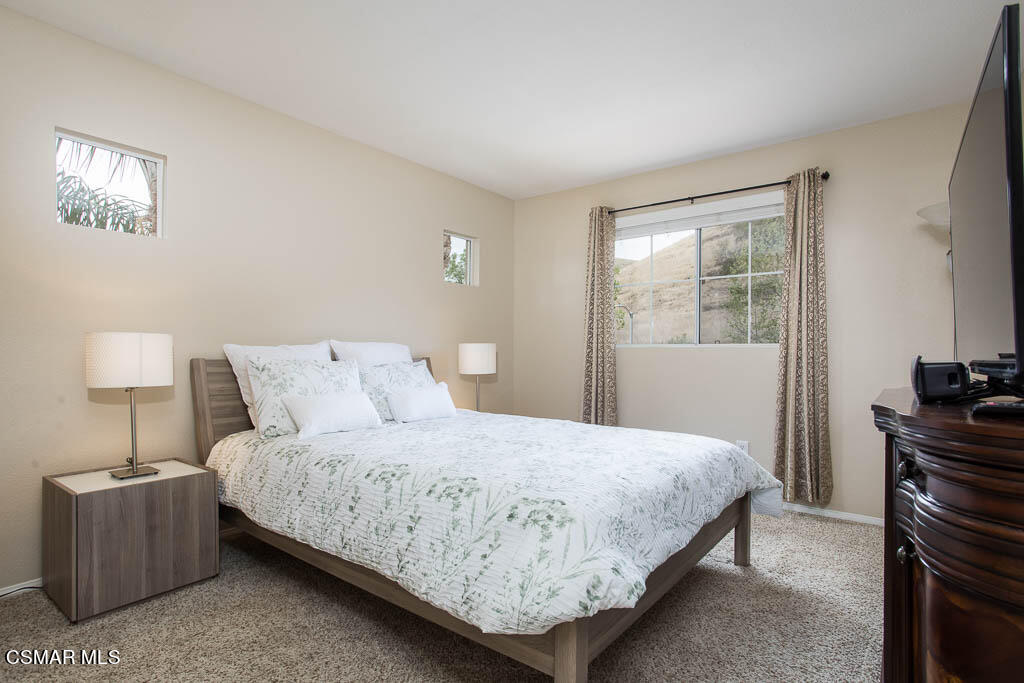 1902 Winterdew Avenue Simi Valley, CA 93065 - Photo 23 of 29 a bedroom with a bed and a lamp