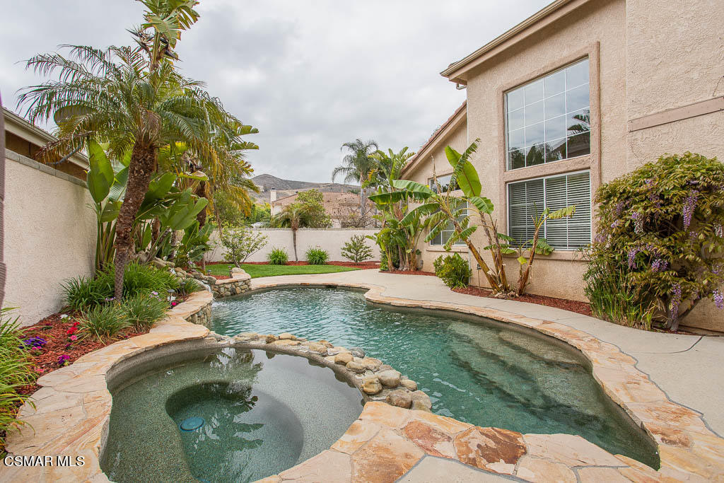 1902 Winterdew Avenue Simi Valley, CA 93065 - Photo 25 of 29 a view of a house with a swimming pool