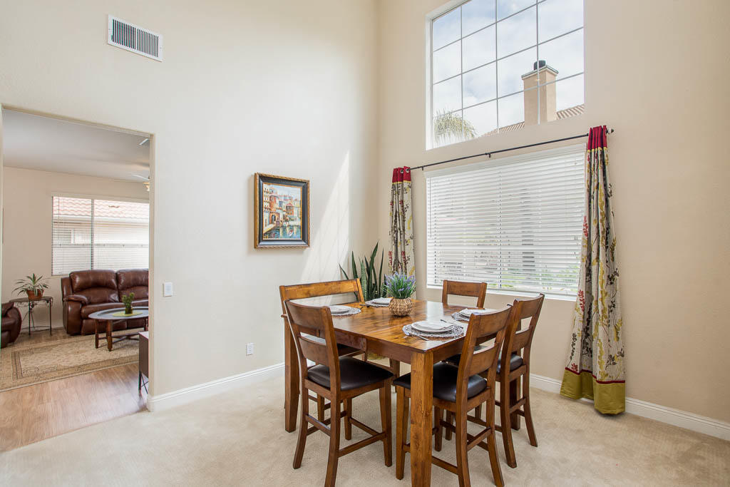 1902 Winterdew Avenue Simi Valley, CA 93065 - Photo 7 of 29 a view of a dining room with furniture and a potted plant