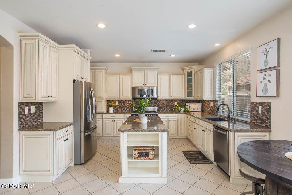 1902 Winterdew Avenue Simi Valley, CA 93065 - Photo 8 of 29 a kitchen with stainless steel appliances a stove sink and refrigerator