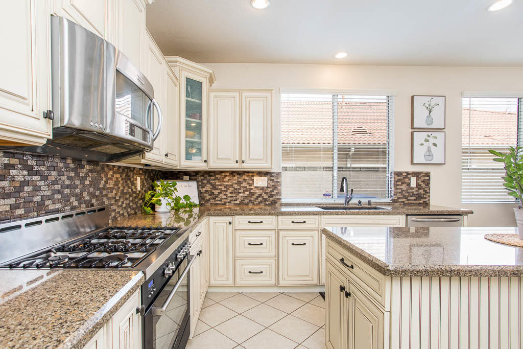 1902 Winterdew Avenue Simi Valley, CA 93065 - Photo 10 of 29 a kitchen with stainless steel appliances granite countertop a stove a sink and a microwave