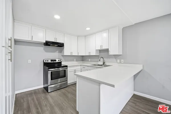 a kitchen with a sink appliances and cabinets