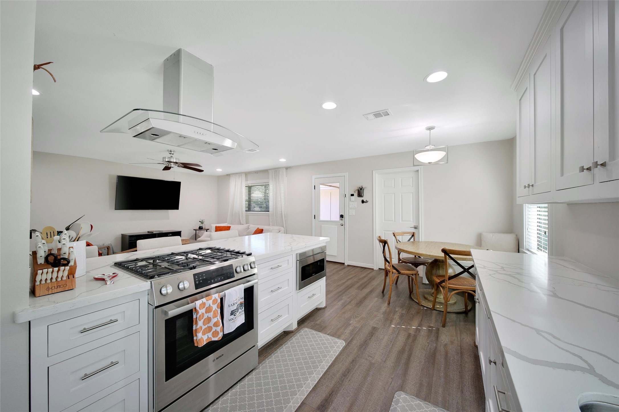 4402 Fallbrook Drive Houston, TX 77018 - Photo 16 of 29 a kitchen with stainless steel appliances a stove a sink dishwasher and a refrigerator with wooden floor