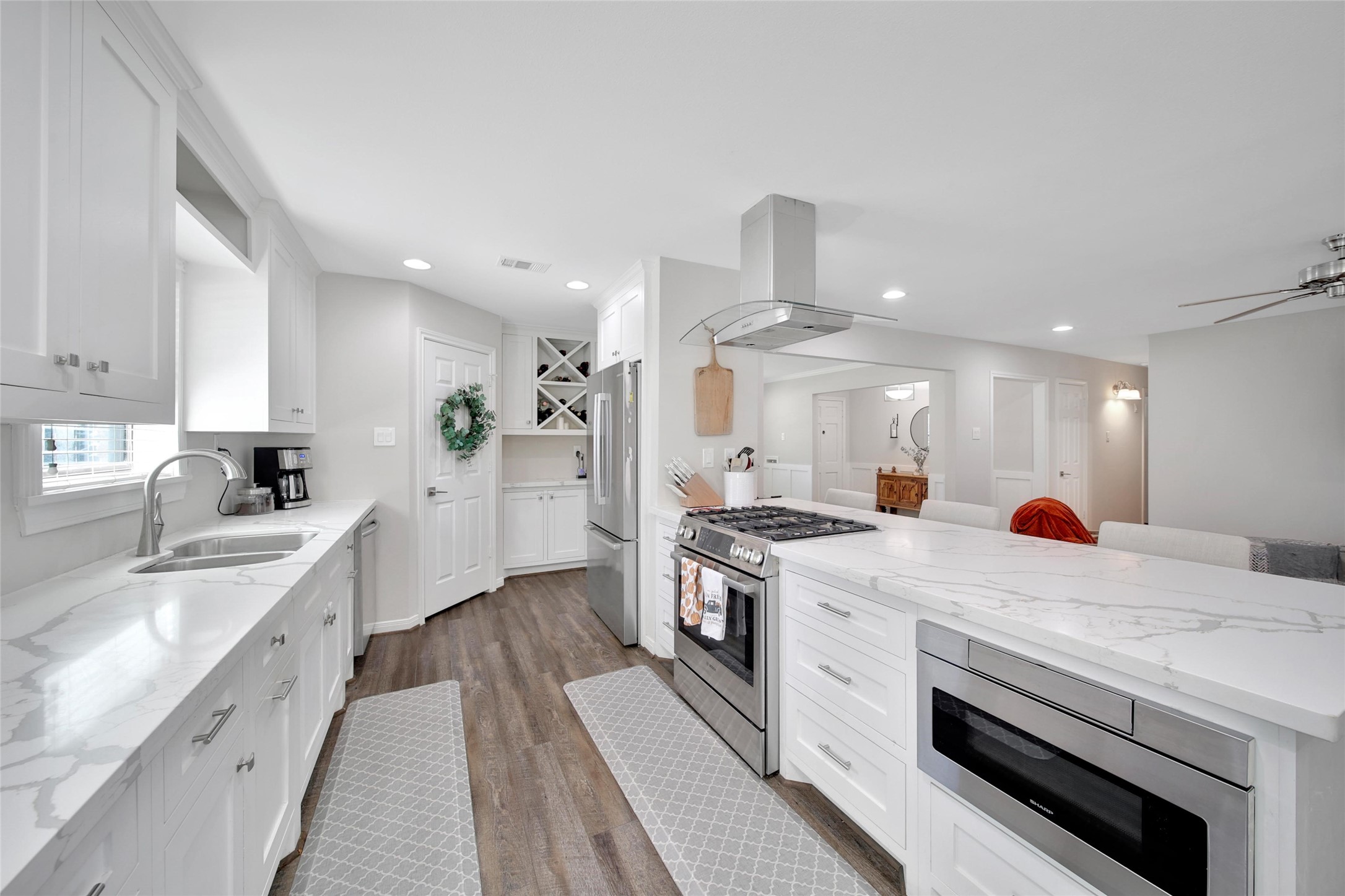4402 Fallbrook Drive Houston, TX 77018 - Photo 17 of 29 a large kitchen with stainless steel appliances and white cabinets