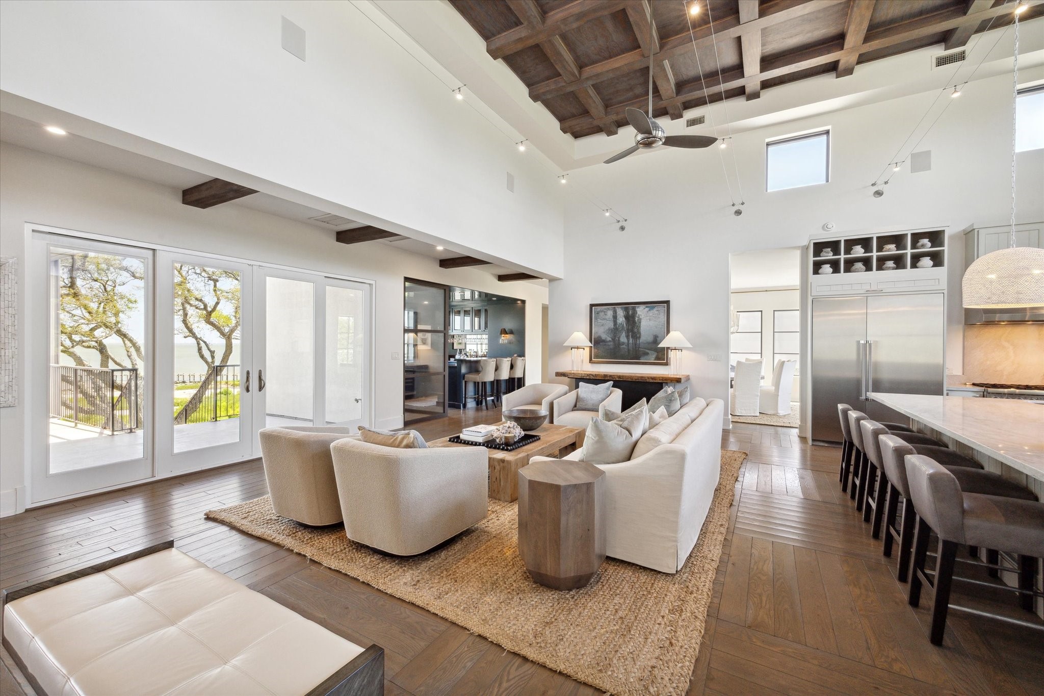 633 Quintana Roo Place Seabrook, TX 77586 - Photo 11 of 47 Large rows of glass sliding doors in both the den and living room open onto an expansive terrace which overlooks the bay.