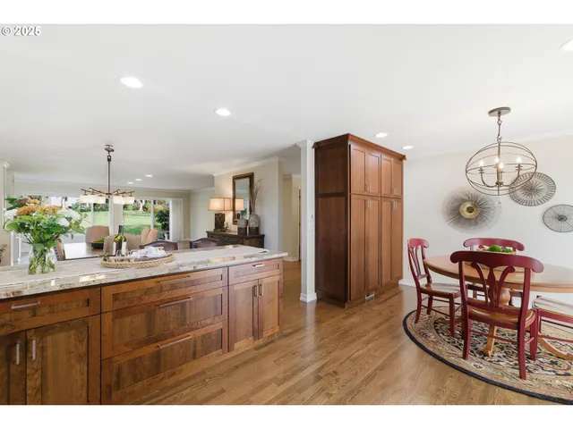 a kitchen with stainless steel appliances granite countertop a sink and a refrigerator