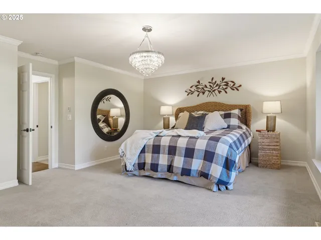 a bedroom with a bed and a chandelier