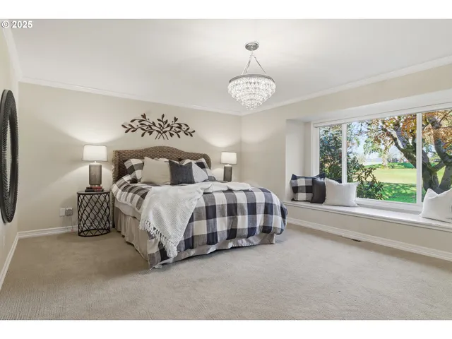 a bedroom with a large bed and a large window