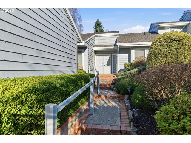 a view of a house with wooden fence