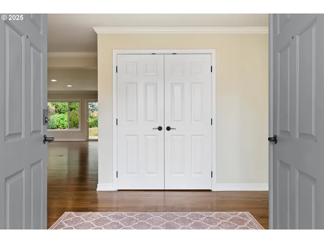 a view of a room with wooden floor and a window