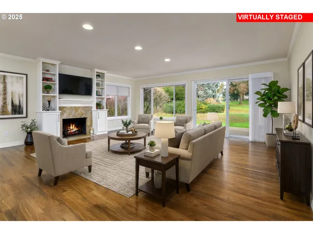 a living room with furniture a flat screen tv and a fireplace